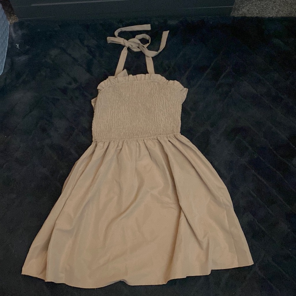 Light brown summer dress. Ties around the neck and back.